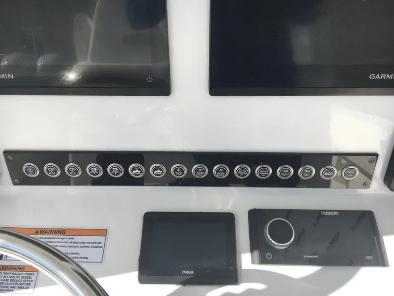 Slide: The Image of Control panel of 2024 Contender 32 ST boat with Garmin and Fusion displays. - 30