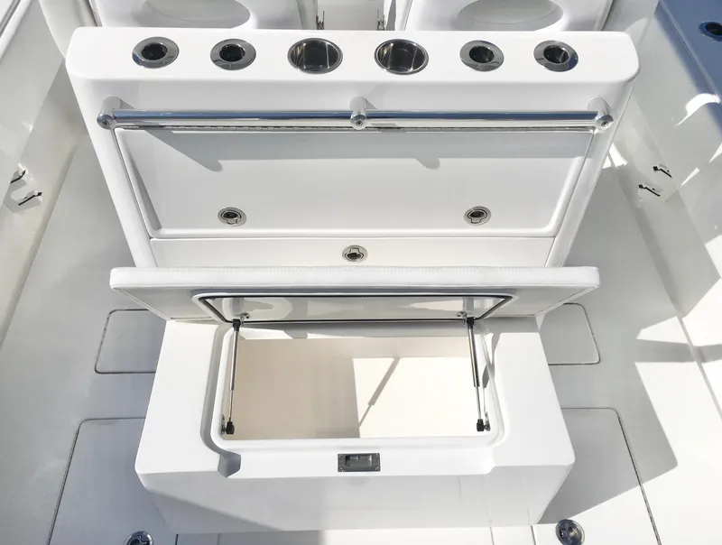 Slide: The Image of 2024 Contender 32 ST boat with open storage compartment and rod holders. - 32