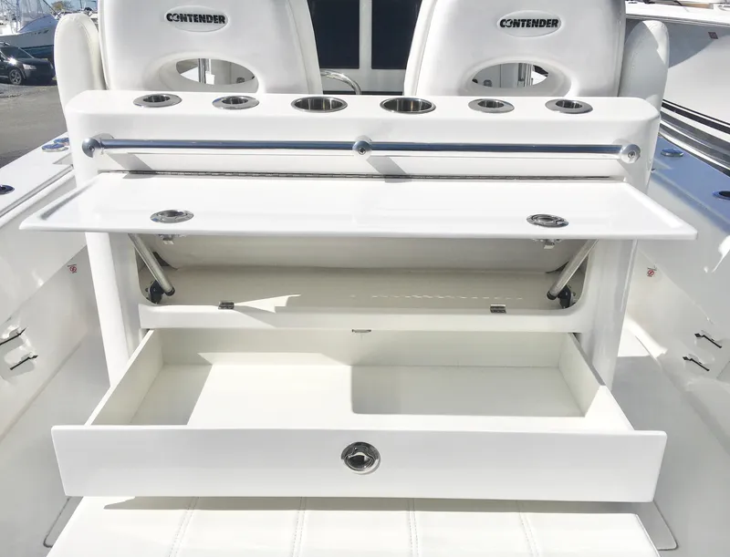 Slide: The Image of 2024 Contender 32 ST boat with open storage compartments and rod holders. - 33