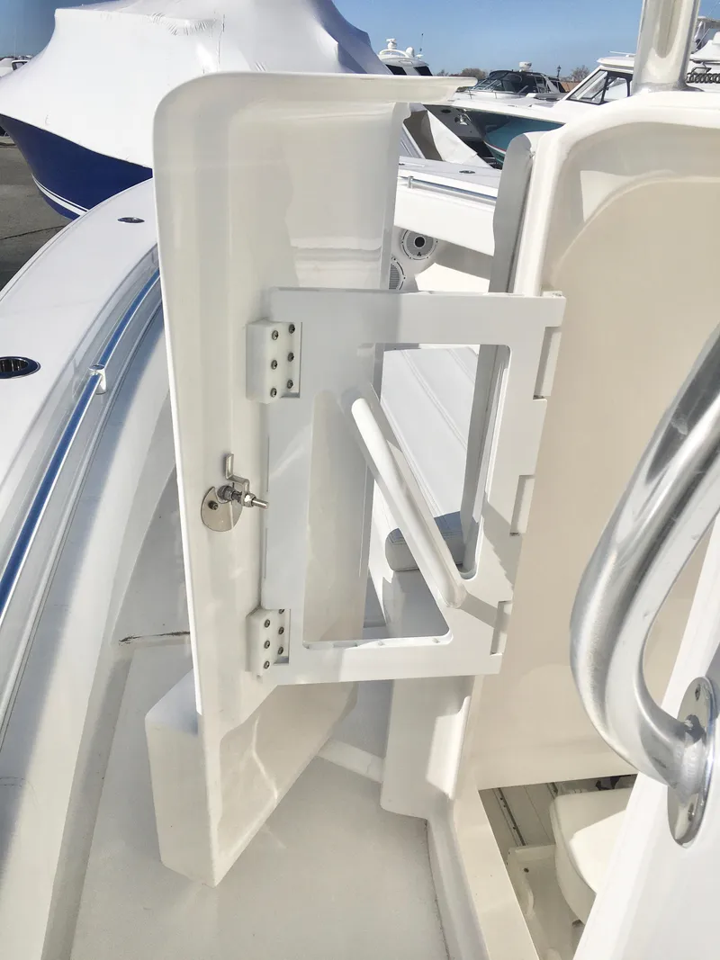 Slide: The Image of 2024 Contender 32 ST boat interior with open storage compartment and sleek design. - 34