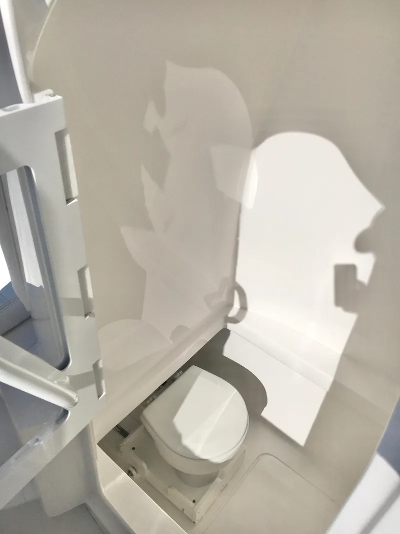 Slide: The Image of 2024 Contender 32 ST boat interior with compact marine toilet. - 36