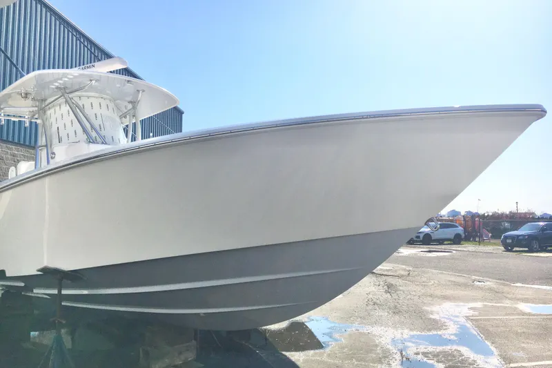 Slide: The Image of 2024 Contender 32 ST boat on display outdoors, showcasing sleek design and modern features. - 4
