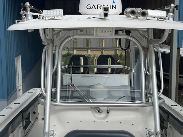 Slide: The Image of 2008 Hydra-Sports 3300 CC boat with Garmin equipment, featuring a sturdy T-top and seating. - 14