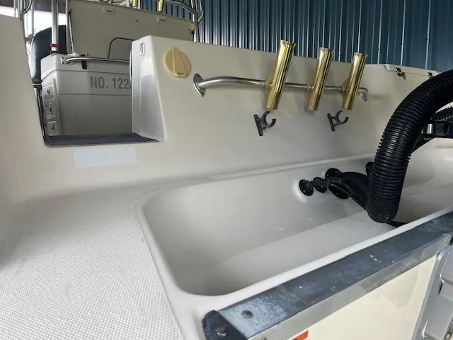 Slide: The Image of 2008 Hydra-Sports 3300 CC boat interior with rod holders and storage compartment. - 15