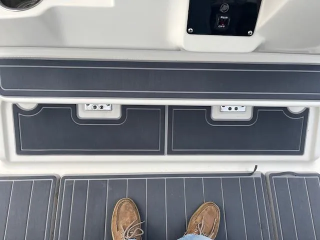 Slide: The Image of 2008 Hydra-Sports 3300 CC boat deck with storage compartments and control panel. - 8