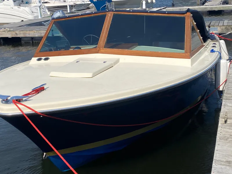 Slide: The Image of 1972 Bertram 25 boat docked at marina, featuring classic design and wooden trim. - 12