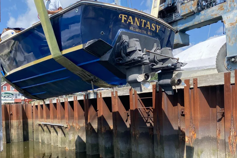 Slide: The Image of 1972 Bertram 25 boat "Fantasy" being lifted at a dock in Falmouth, MA. - 3