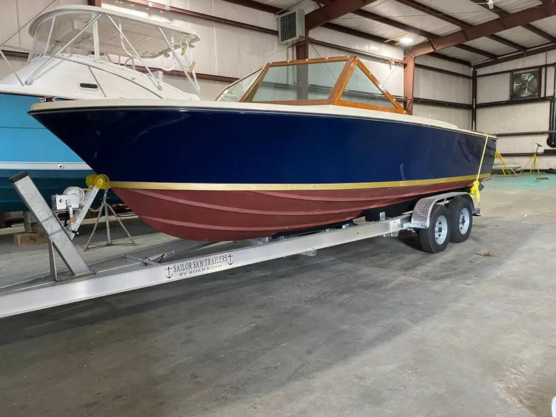 Slide: The Image of 1972 Bertram 25 boat on trailer in indoor storage facility. - 5