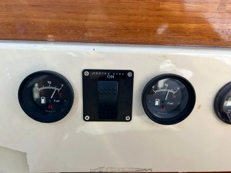 Slide: The Image of 1972 Bertram 25 dashboard with fuel gauges and engine sync switch. - 8