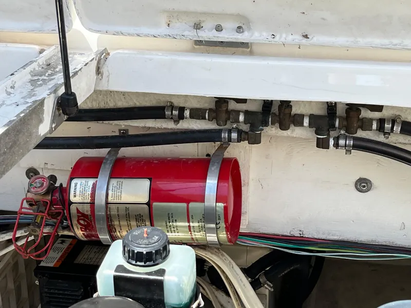Slide: The Image of Bayliner 3258 Ciera Command Bridge DX 2000 engine compartment with fire extinguisher and wiring. - 10