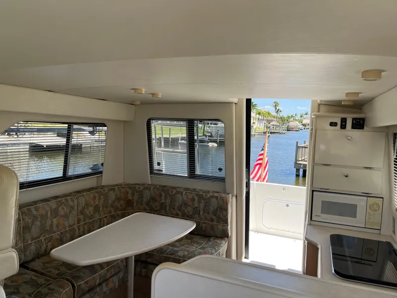 Slide: The Image of Interior of 2000 Bayliner 3258 Ciera Command Bridge DX with dining area and kitchen. - 16