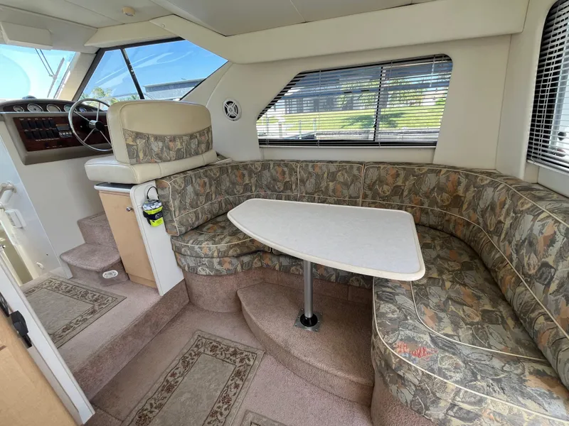 Slide: The Image of Interior of 2000 Bayliner 3258 Ciera Command Bridge DX with dining area and helm. - 17