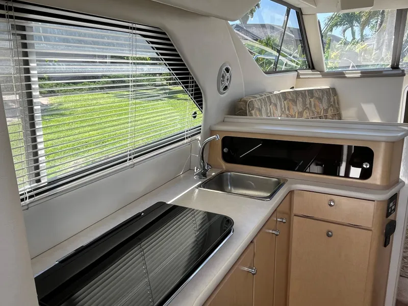 Slide: The Image of Interior of 2000 Bayliner 3258 Ciera Command Bridge DX with kitchen and seating area. - 18