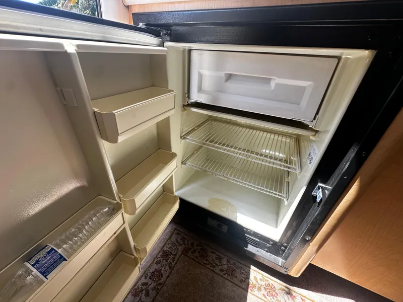 Slide: The Image of Open refrigerator inside a 2000 Bayliner 3258 Ciera Command Bridge DX boat. - 19