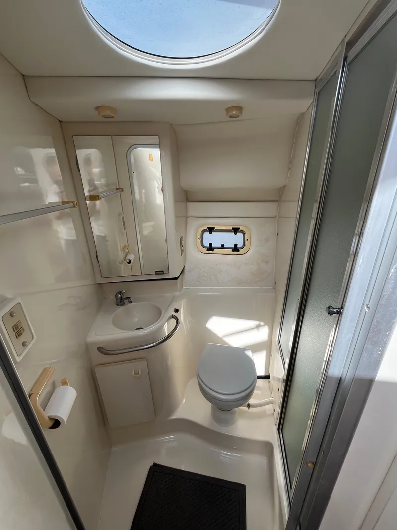 Slide: The Image of 2000 Bayliner 3258 Ciera Command Bridge DX bathroom with sink, toilet, and shower. - 32