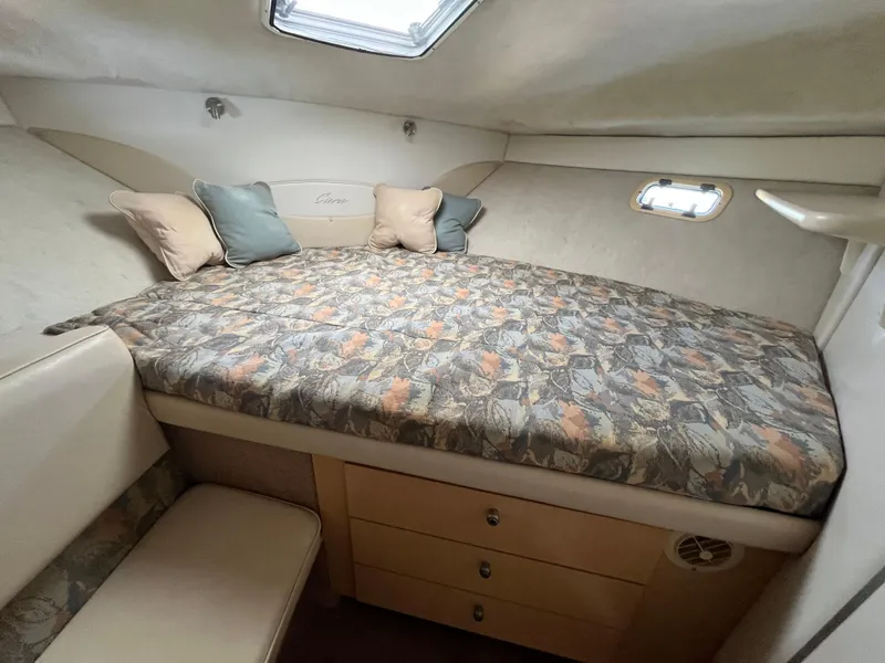 Slide: The Image of Bayliner 3258 Ciera Command Bridge DX 2000 cabin interior with bed and skylight. - 35