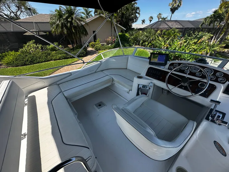 Slide: The Image of 2000 Bayliner 3258 Ciera Command Bridge DX cockpit with white seating and control panel. - 39