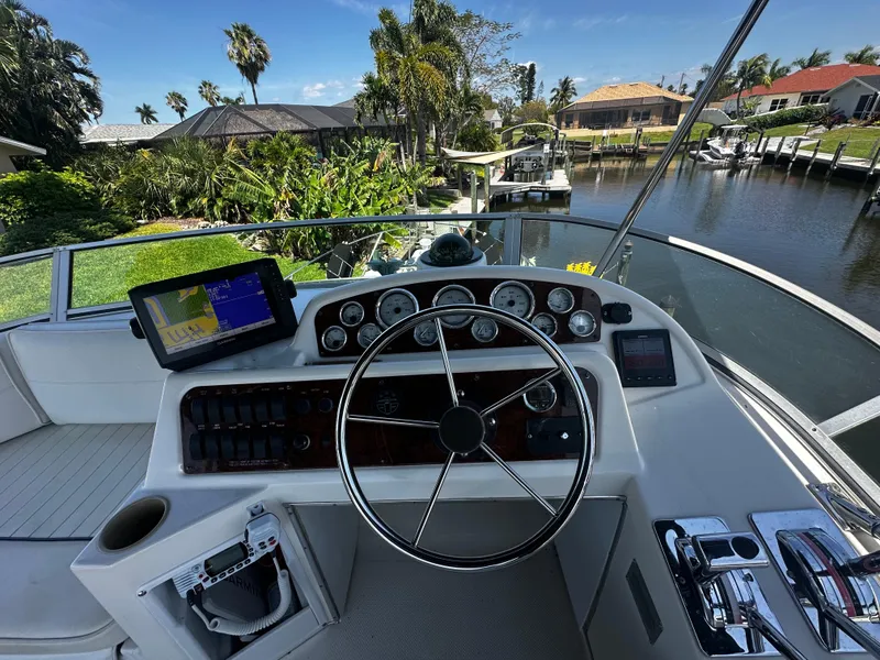 Slide: The Image of Bayliner 3258 Ciera Command Bridge DX 2000 helm with navigation system and canal view. - 47