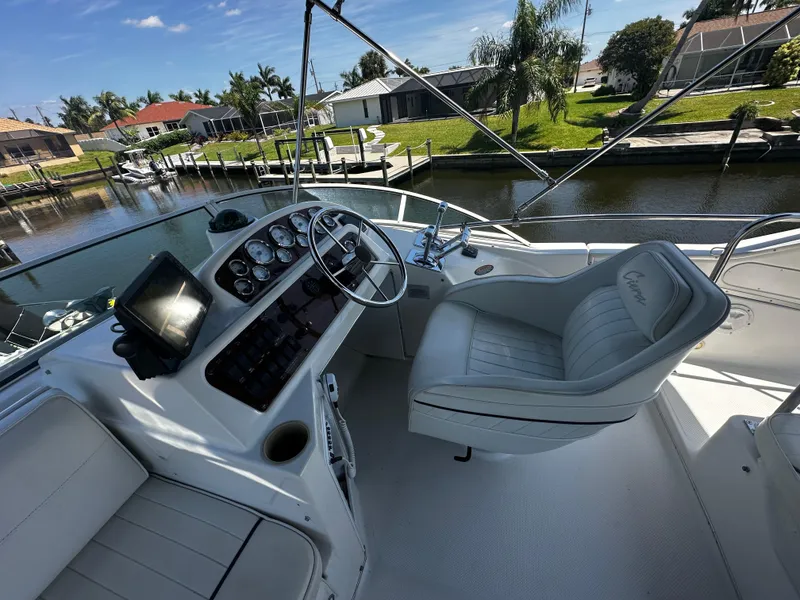 Slide: The Image of Bayliner 3258 Ciera Command Bridge DX 2000 model, helm station with captain's chair and navigation equipment. - 48