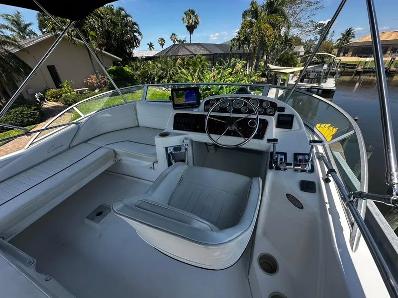 Slide: The Image of 2000 Bayliner 3258 Ciera Command Bridge DX cockpit with steering wheel and seating. - 49