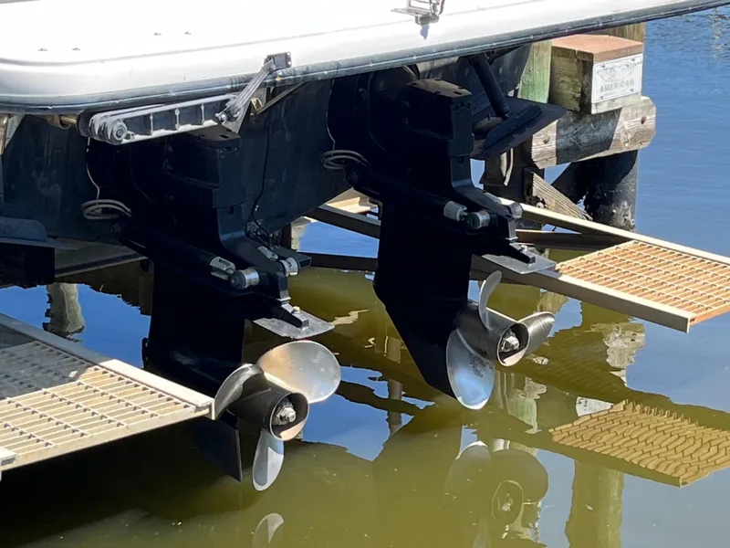 Slide: The Image of Bayliner 3258 Ciera Command Bridge DX 2000 boat propellers and stern drives in water. - 6