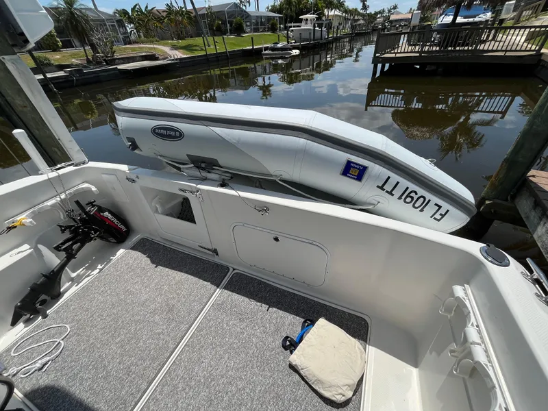 Slide: The Image of Bayliner 3258 Ciera Command Bridge DX 2000 model docked with inflatable boat. - 8
