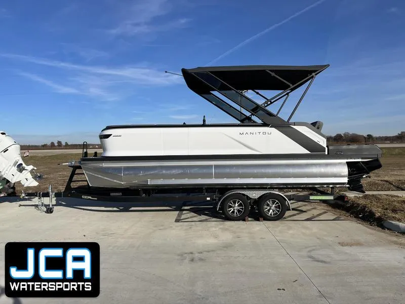 The Image of 2024 Manitou Cruise 22 Max Bench V-Toon pontoon boat on trailer at JCA Watersports. - 0