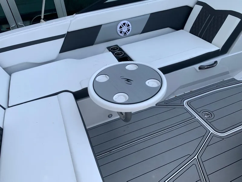 Slide: The Image of 2024 Monterey M-225 boat interior with seating and round table. - 5