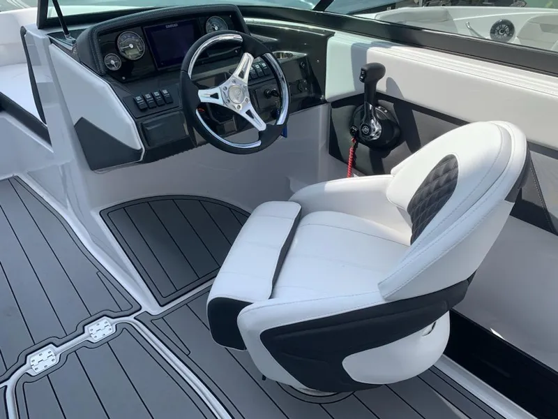 Slide: The Image of 2024 Monterey M-225 boat cockpit with steering wheel and captain's chair. - 6