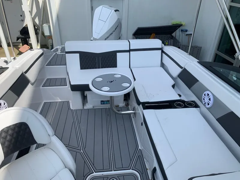 Slide: The Image of 2024 Monterey M-225 boat interior with white seating and table. - 8