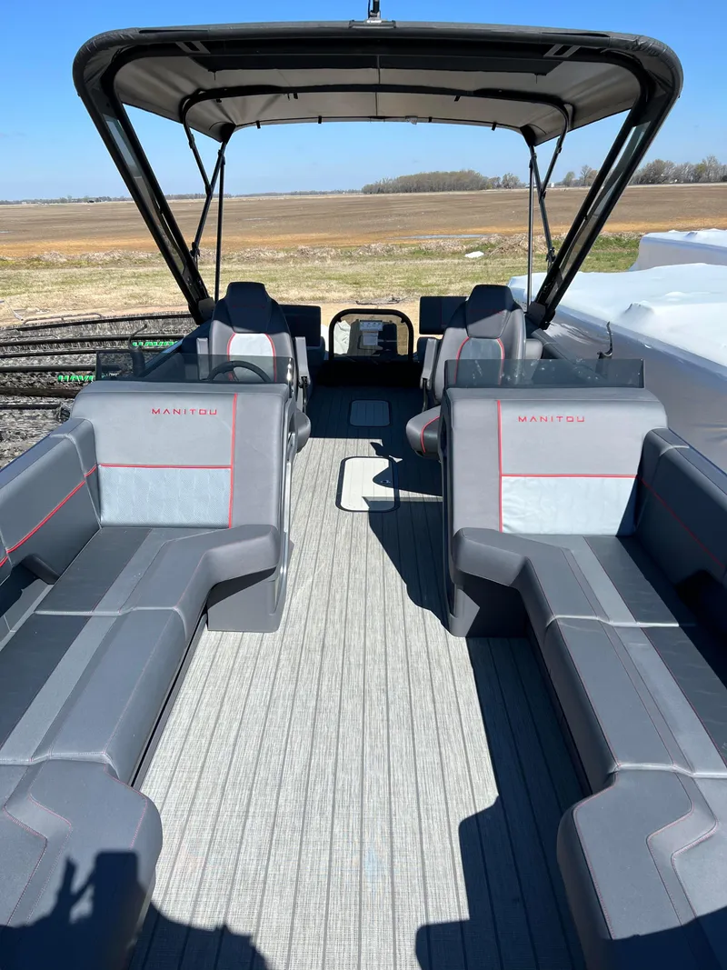 Slide: The Image of 2024 Manitou EXPLORE 24 MAX NAVIGATOR VTOON interior with spacious seating and canopy. - 2