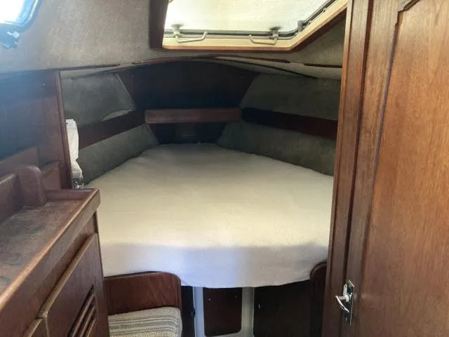 Slide: The Image of 1980 Sceptre 36 boat cabin with a cozy bed and wooden interior. - 16