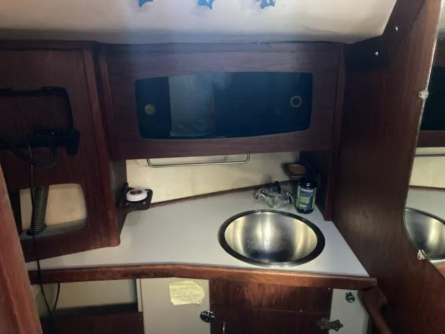 Slide: The Image of 1980 Sceptre 36 yacht interior with sink and wooden cabinetry. - 18