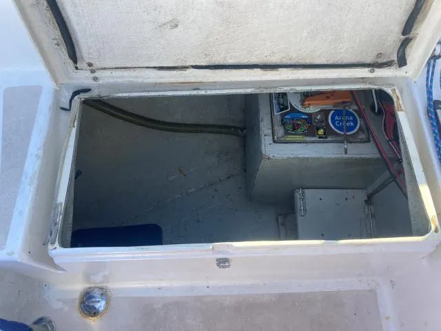 Slide: The Image of Open hatch of a 1980 Sceptre 36 boat showing storage and electrical components. - 25