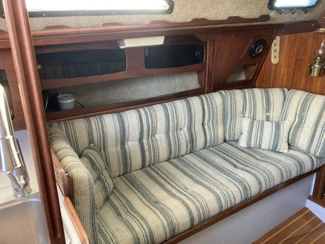 Slide: The Image of 1980 Sceptre 36 sailboat interior with striped cushioned seating and wooden cabinetry. - 3