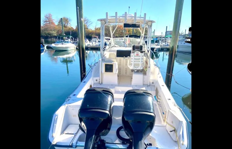 Slide: The Image of 1999 Grady-White 268 Islander boat with twin outboard motors docked at a marina. - 1