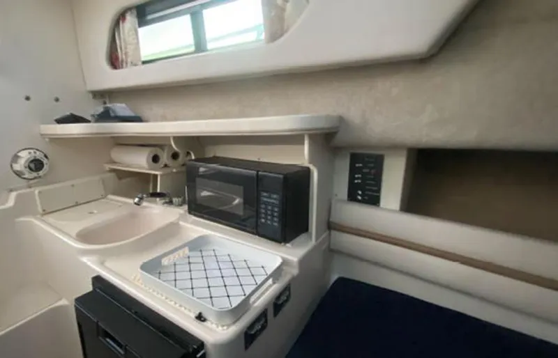 Slide: The Image of 1999 Grady-White 268 Islander cabin kitchen with microwave and sink. - 5