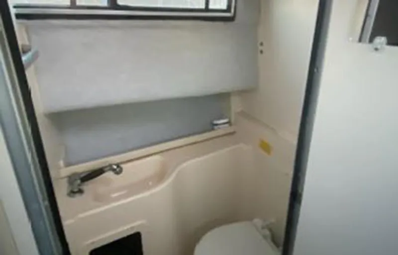 Slide: The Image of 1999 Grady-White 268 Islander boat bathroom with sink and toilet. - 6