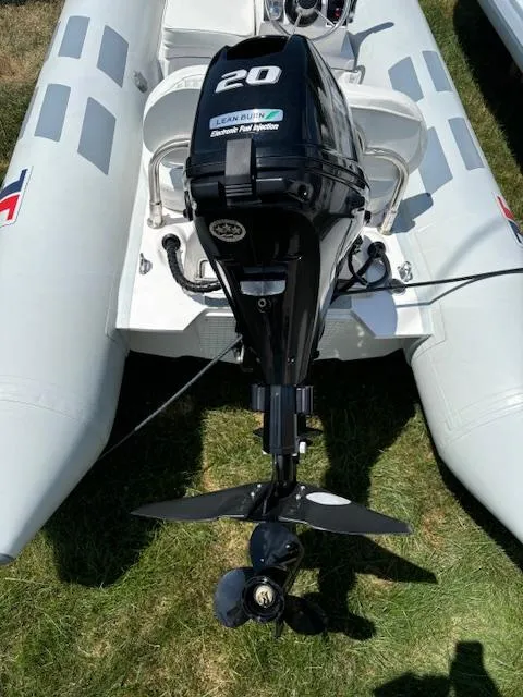 Slide: The Image of 2024 Inmar 320RYS inflatable boat with a 20 HP outboard motor. - 2