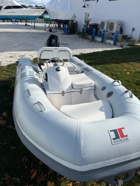 Slide: The Image of 2024 Inmar 320RYS inflatable boat in a marina setting. - 5