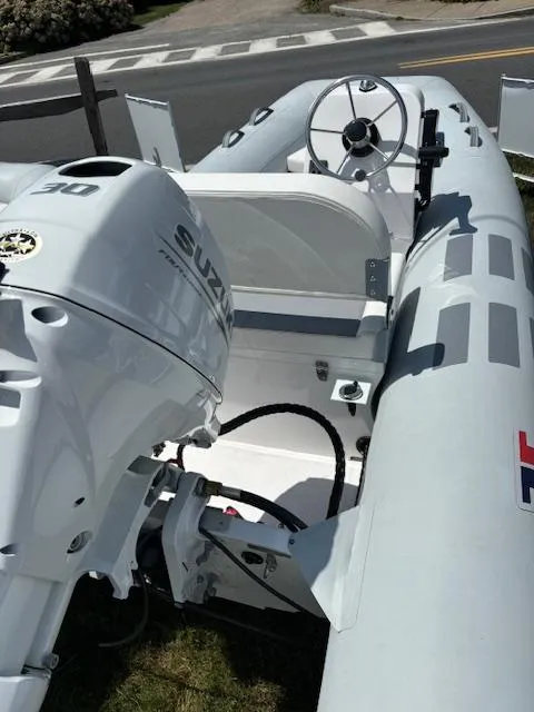 Slide: The Image of 2024 Inmar 360RYS inflatable boat with Suzuki outboard motor. - 2