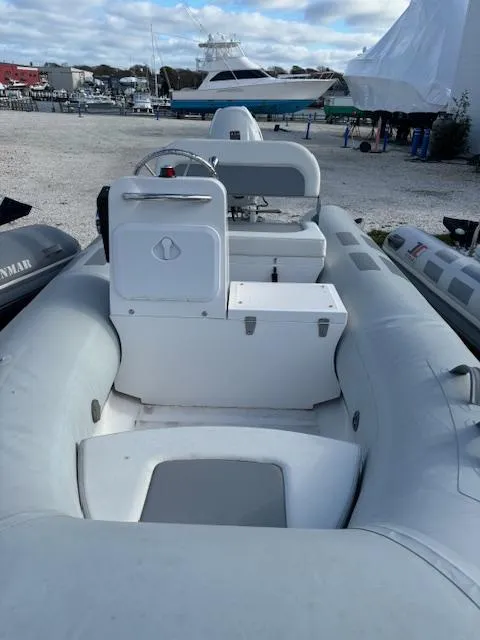 Slide: The Image of 2024 Inmar 360RYS inflatable boat, docked with other vessels in a marina. - 7