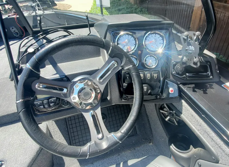 Slide: The Image of 2024 Tracker Targa V-19 WT boat dashboard with steering wheel and instrument panel. - 2