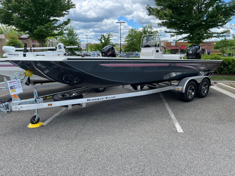 The Image of 2024 Ranger RB210 boat on a trailer in a parking lot. - 0