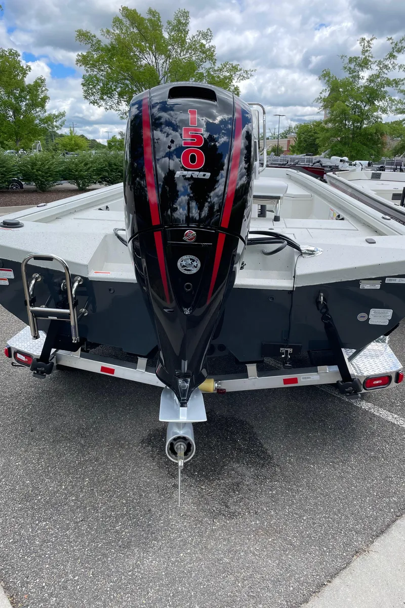 Slide: The Image of 2024 Ranger RB210 boat with a powerful 150 HP outboard motor. - 3