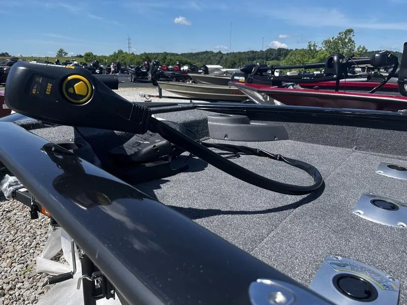 Slide: The Image of 2024 Tracker Pro Team 175 TF boat deck with control panel and fishing rod holders. - 2