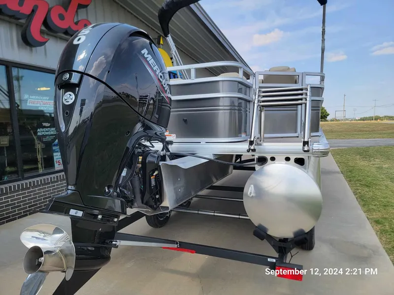 Slide: The Image of 2024 Sun Tracker Fishin' Barge 22 DLX with Mercury outboard motor, docked outdoors. - 11