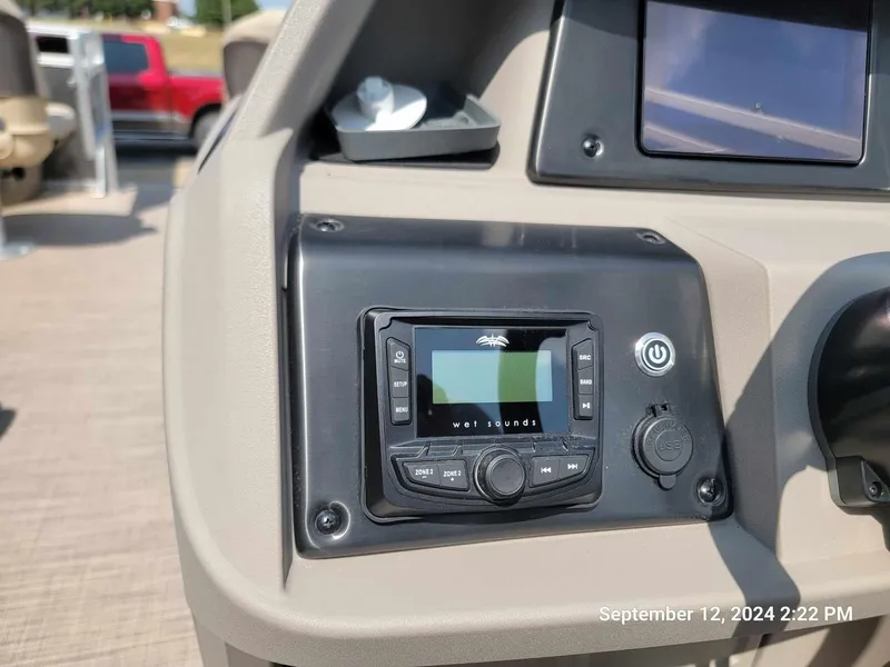 Slide: The Image of Control panel of 2024 Sun Tracker Fishin' Barge 22 DLX with audio system. - 2