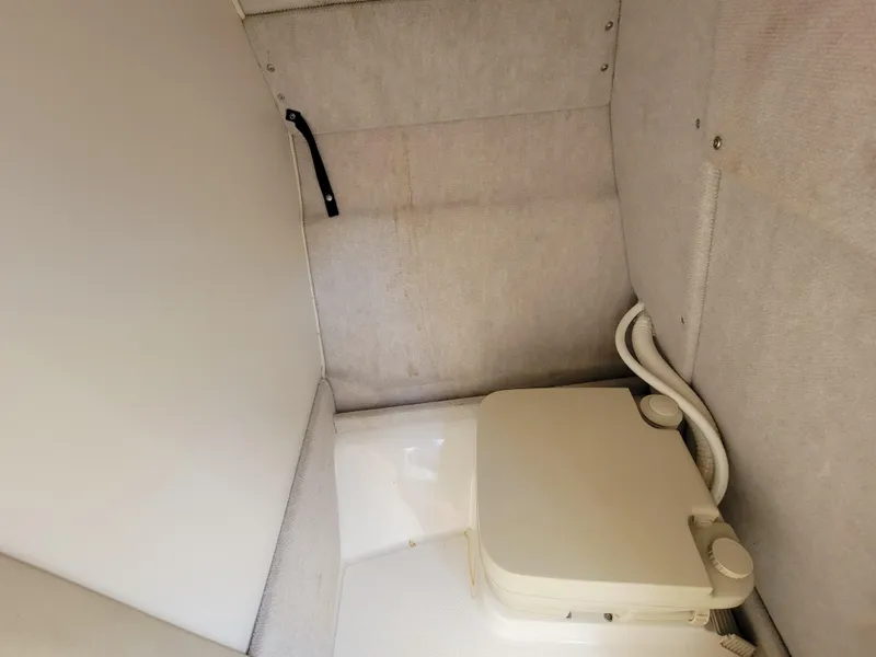 Slide: The Image of 1998 Sea Ray 260 Overnighter cabin with portable toilet. - 10
