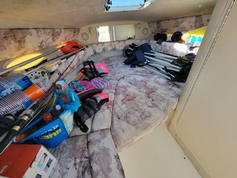 Slide: The Image of Interior of a 1998 Sea Ray 260 Overnighter boat with fishing gear and supplies. - 11